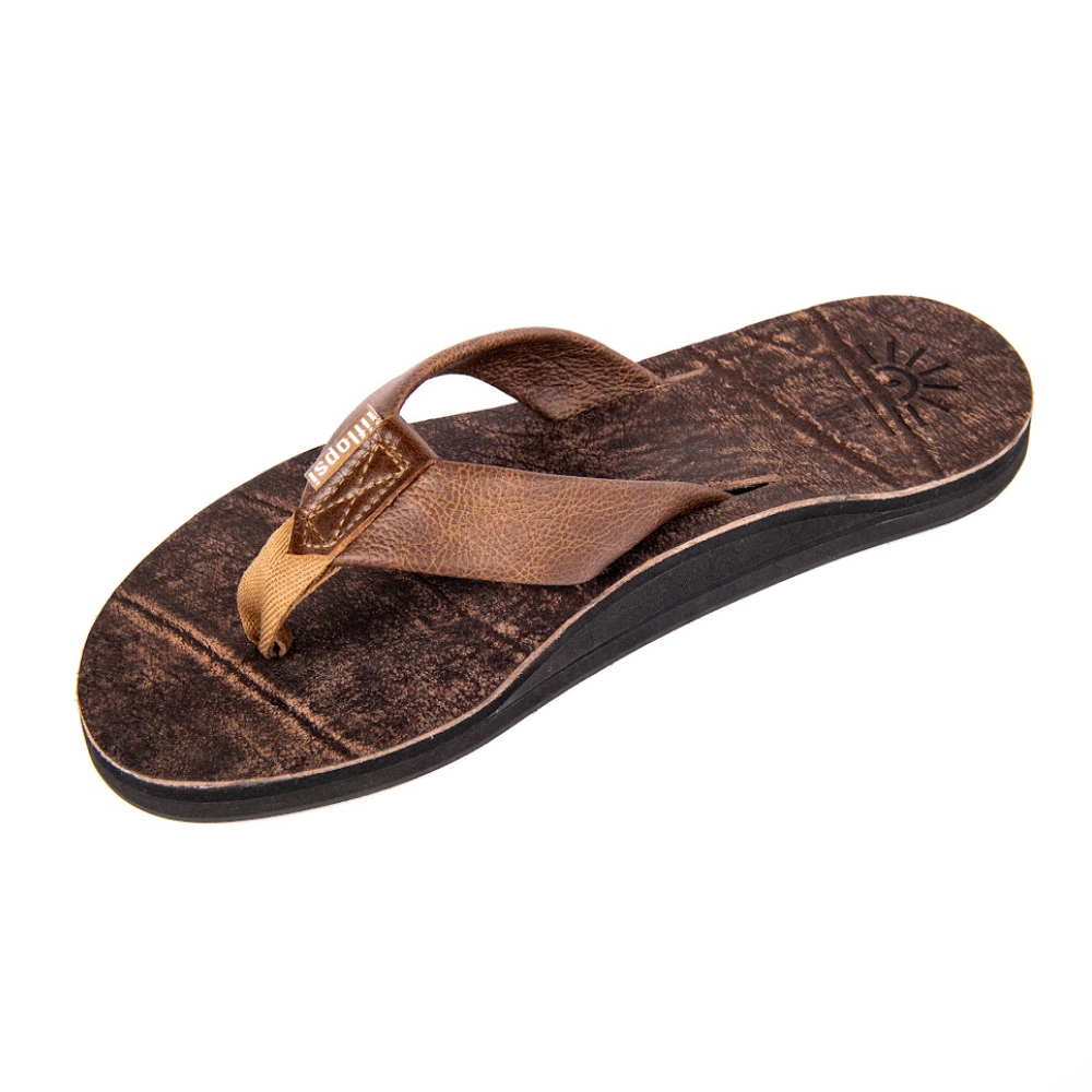 Brown sandal with a textured sole on a white background